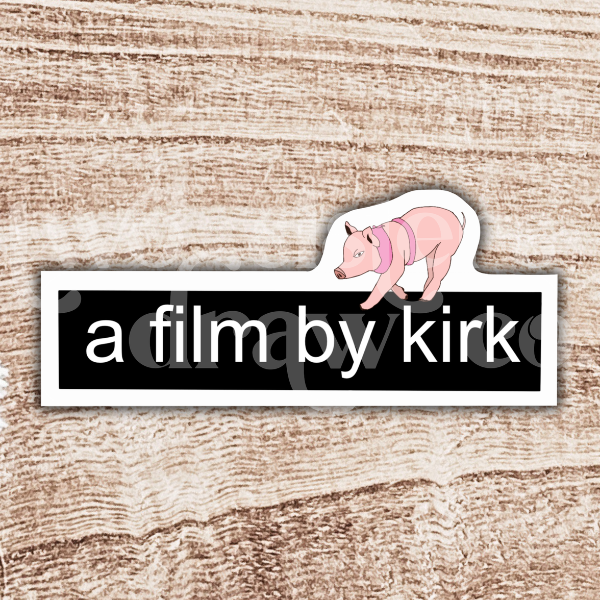 Gilmore Girls sticker with the text 'a film by kirk' and a mini pig on top on a wooden background.