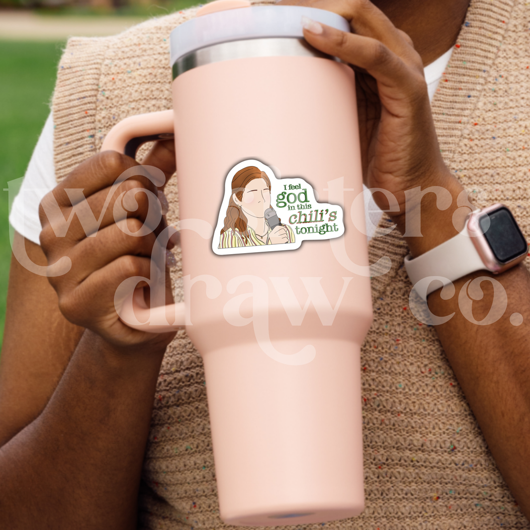 Person holding a tumbler with a hand-drawn sticker of Pam Beesley with a microphone and the text ‘I feel God in this Chili’s tonight.’