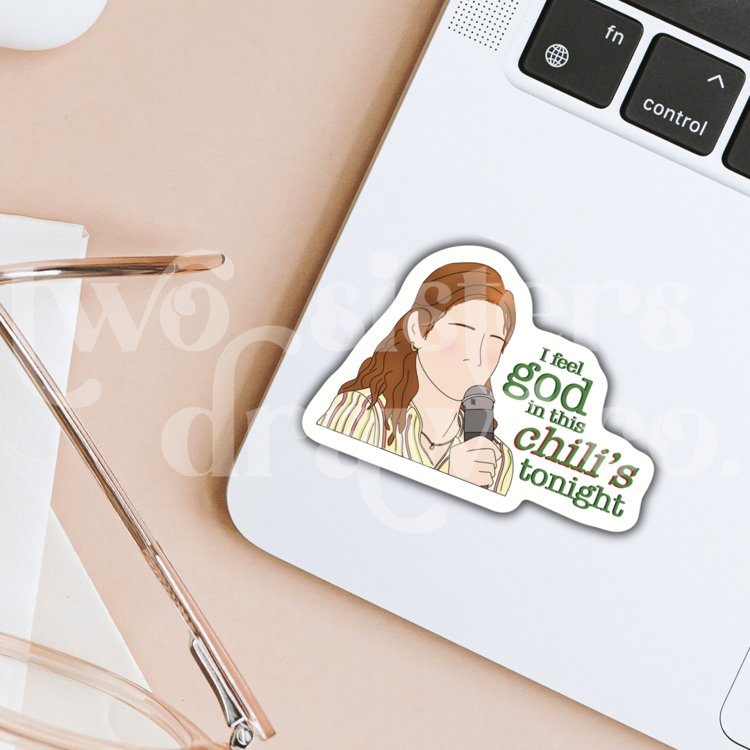 Hand-drawn sticker of Pam Beesley with a microphone and the text ‘I feel God in this Chili’s tonight’ on a laptop.