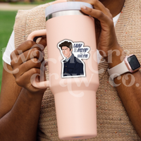 Person holding a tumbler with a hand-drawn Jess Mariano sticker with the text ‘why did you drop out of Yale?!’ beside him. 