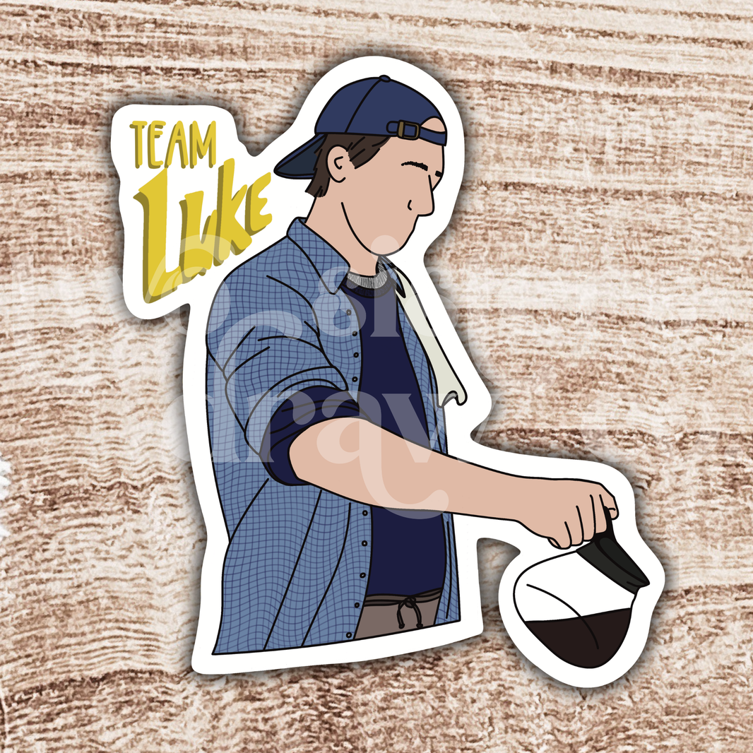 Hand-drawn sticker of Luke Danes pouring coffee with the test ‘Team Luke’ with a wooden background. 
