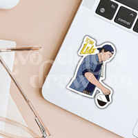 Hand-drawn sticker of Luke Danes pouring coffee with the text ‘Team Luke’ on a laptop. 